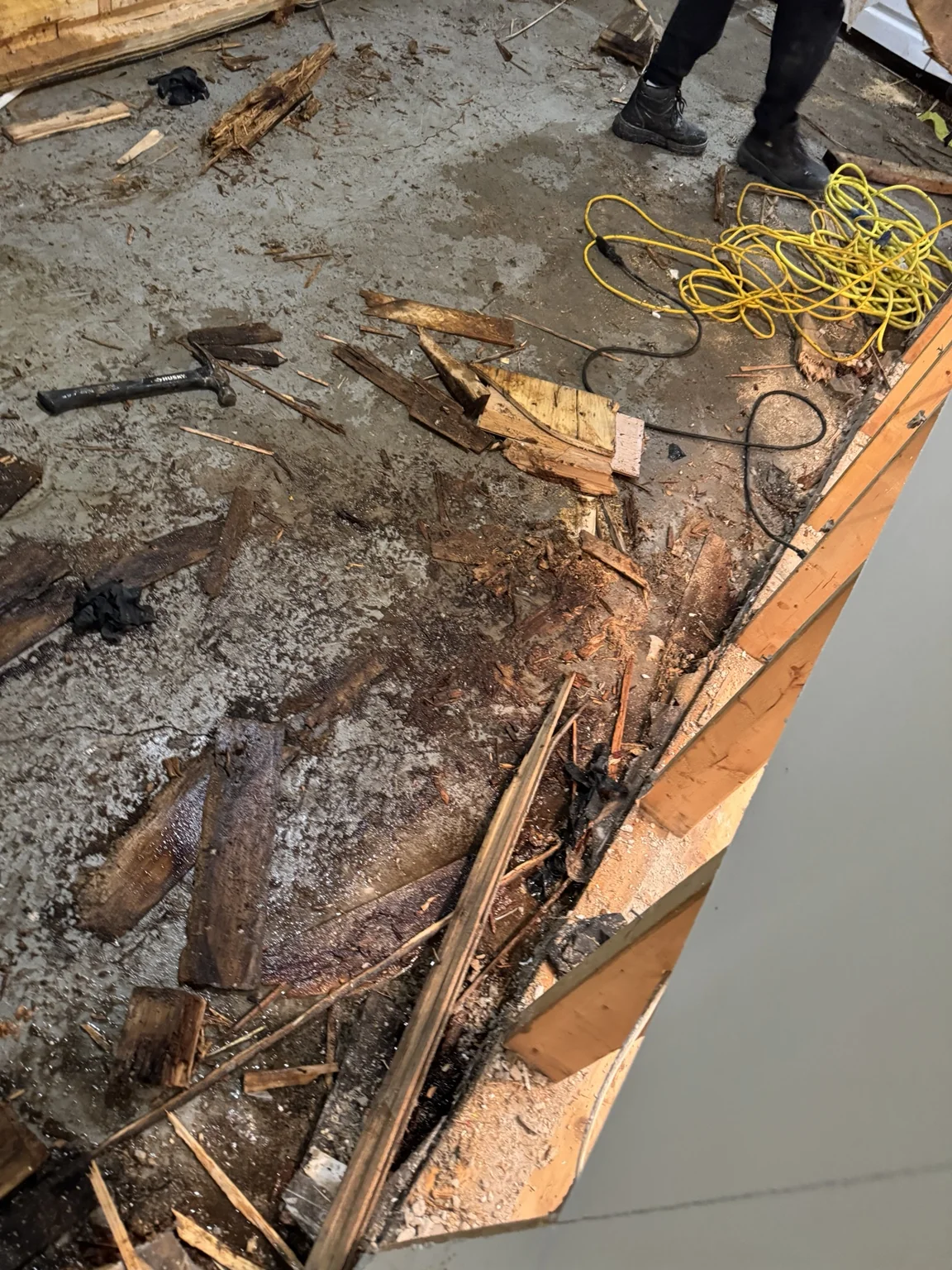 Floor covering and timber being removed during interior demolition