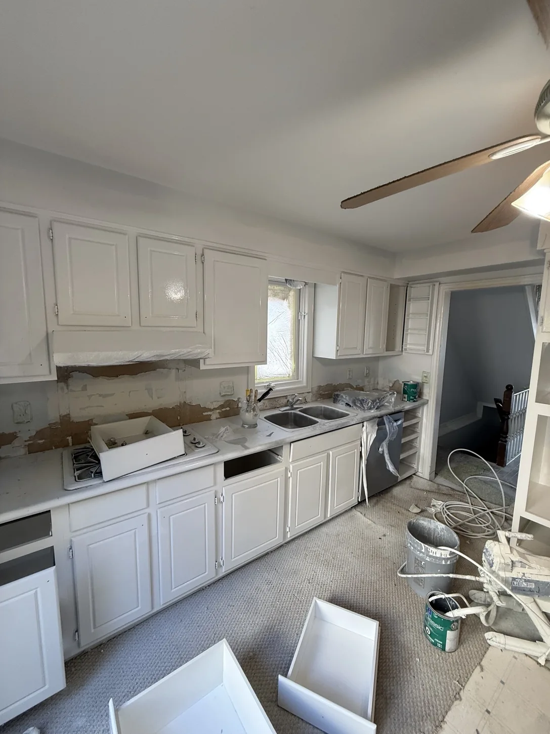 White kitchen cabinet fronts during refinishing and installation